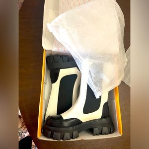 BRAND NEW IN THE BOX NEVER USED Chelsea boot lifted with a lugged platform heel.